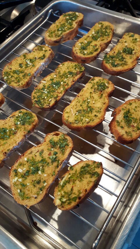 Cooked garlic bread on roasting tray wire rack