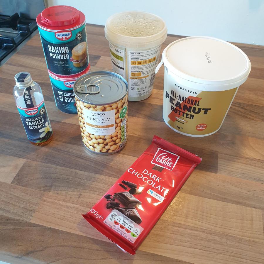 Ingredients shown for chickpea blondies; vanilla extract, baking powder, bicarbonate of soda, chickpeas, peanut butter and homemade apple sauce.